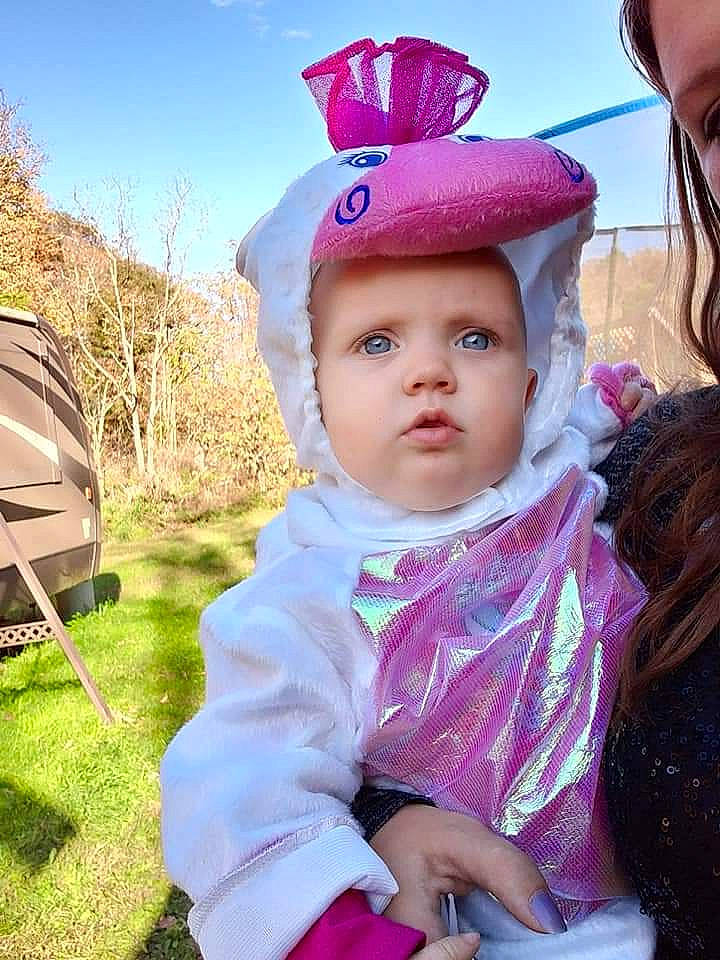 Lilyanna is registered to the contest to win money with this photo: baby, child, fun, hat, head, headgear, headwear, outerwear, person, pink, plant, purple, smile, toddler