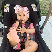 Aubrielle joined the competition — help win amazing prizes! accessories, baby, baseballcap, cap, clothing, face, grass, hat, head, outdoors, person, photography, plant, portrait, shorts, stroller, sunglasses, swimwear, transportation, vehicle