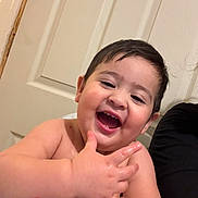 Tyron is registered to the contest to win money with this photo: toddler, child, happy, smiling, face, hand, skin, indoor, door, table, person, baby, expression, cute, playful, young, portrait, laughing, wet_skin, human