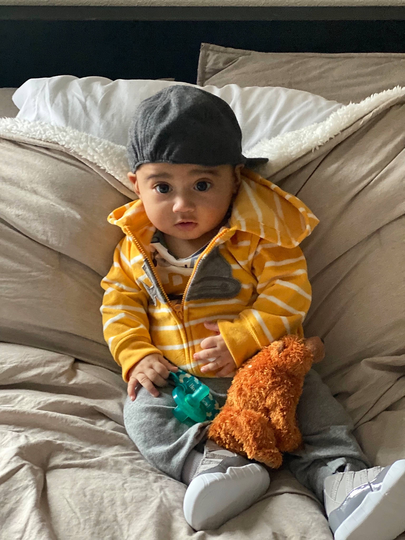 Dani joined the competition — help win amazing prizes! child, comfort, facial_expression, fun, fur, grass, headwear, hoodie, lap, leisure, linens, outerwear, person, product, room, sitting, sleeve, toddler, vacation, vertebrate