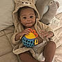 baby, child, hoodie, plush, toy, diaper, bed, pillow, quilt, face, hands, feet, cute, indoor, relaxing, soft, comfort, playful, smiling, infant