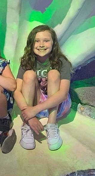 Lilly joined the competition — help win amazing prizes! cool, face, fun, grass, hair, happy, head, human_leg, joy, knee, leisure, outdoor_shoe, person, recreation, sandal, shorts, smile, sneakers, sock, thigh