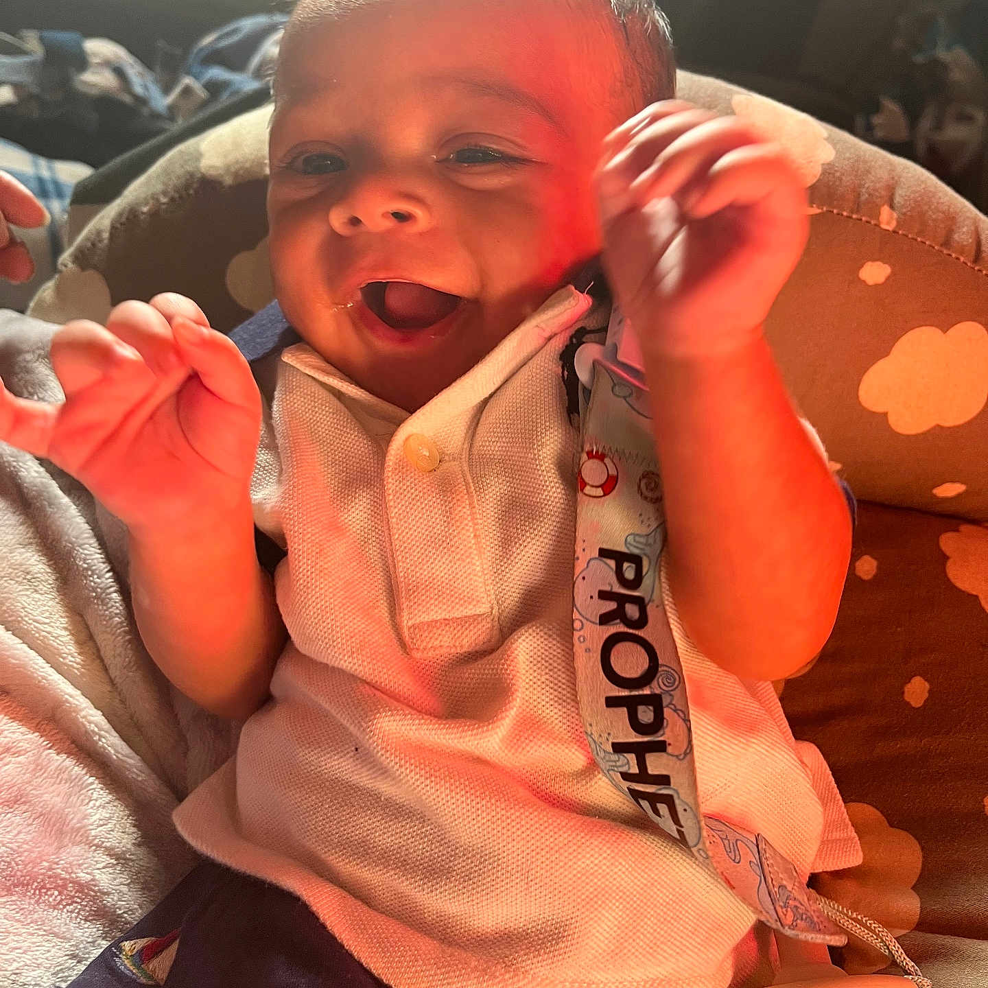 Prophet is registered to the contest to win money with this photo: baby, babylaughing, bodypart, clothing, couch, cushion, face, finger, furniture, hand, happy, head, homedecor, laughing, pants, person, photography, portrait, smile, t_shirt