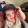 baby, child, cap, hat, infant, smiling, face, hand, clothing, seat, quilt, indoor, cute, happy, person, closeup, portrait, casual, holding, cheeks