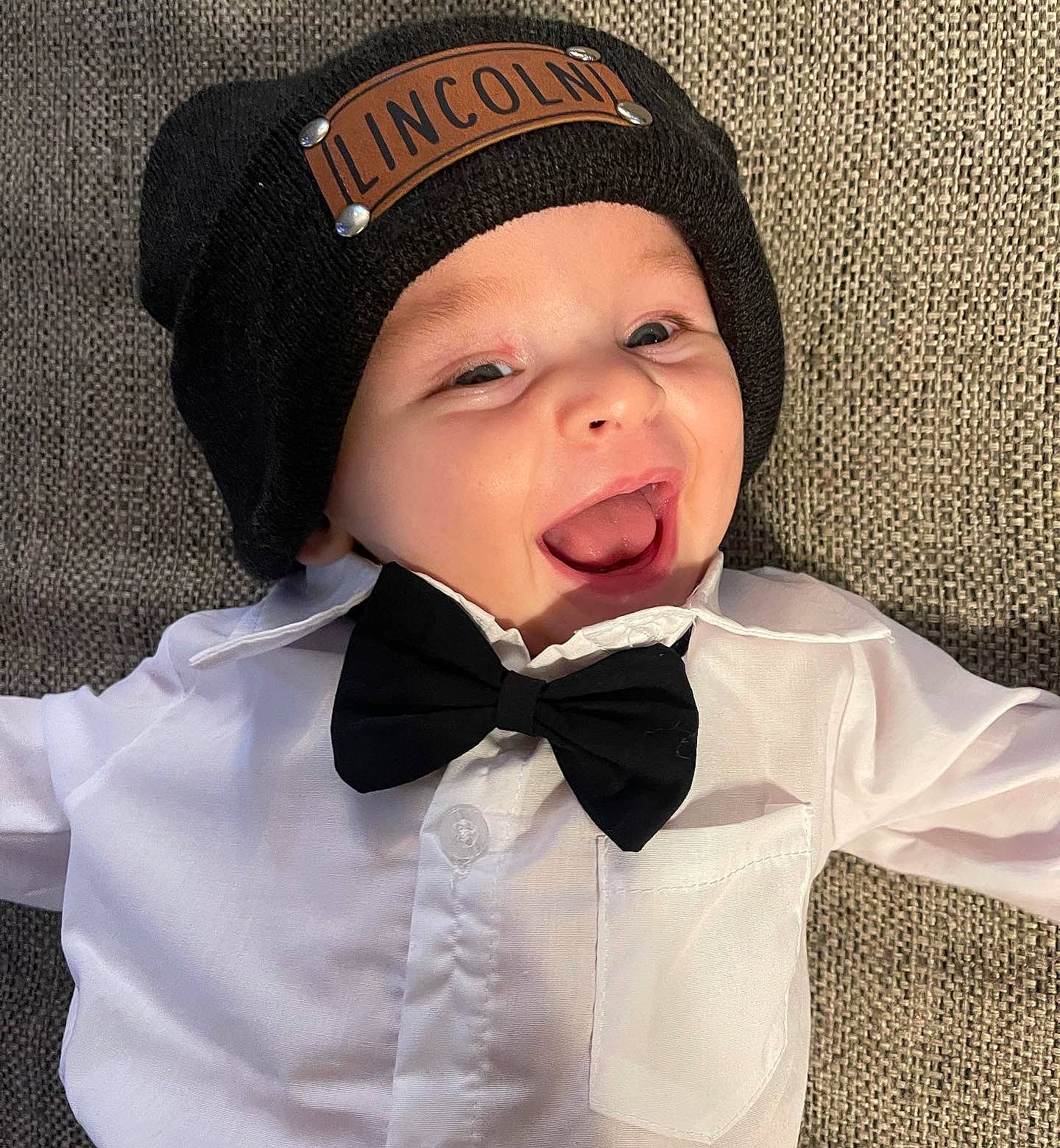 Lincoln is registered to the contest to win money with this photo: baby, baby_toddler_clothing, beard, blazer, bow_tie, cap, collar, dress_shirt, eye, eyebrow, hat, headwear, human_body, jacket, lip, neck, outerwear, person, sleeve, suit