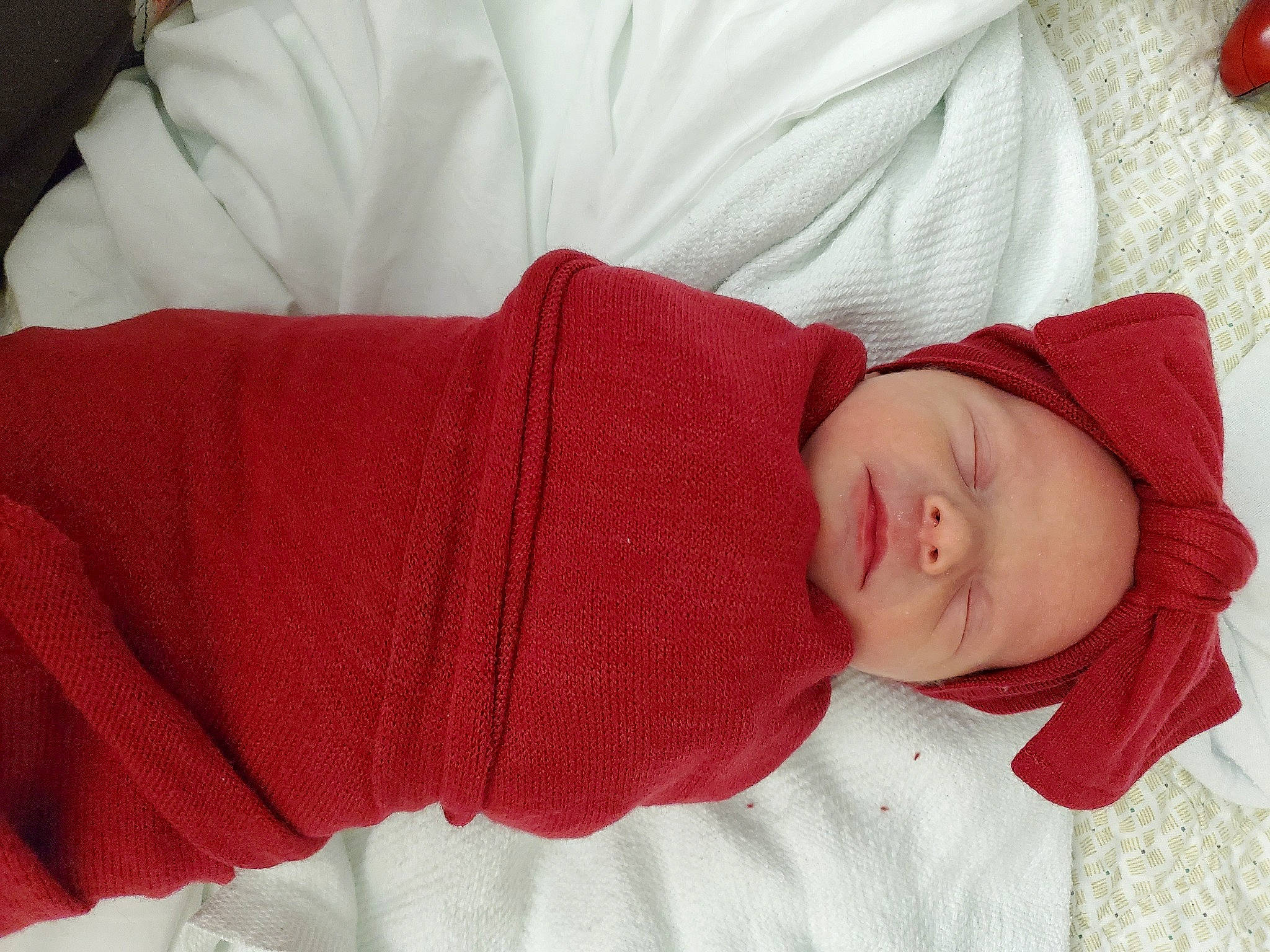 Gabriella joined the competition — help win amazing prizes! baby, baby_sleeping, baby_toddler_clothing, bedtime, carmine, child, comfort, elbow, gesture, hat, headgear, knit_cap, linens, pattern, person, red, room, skin, sleeve, toddler