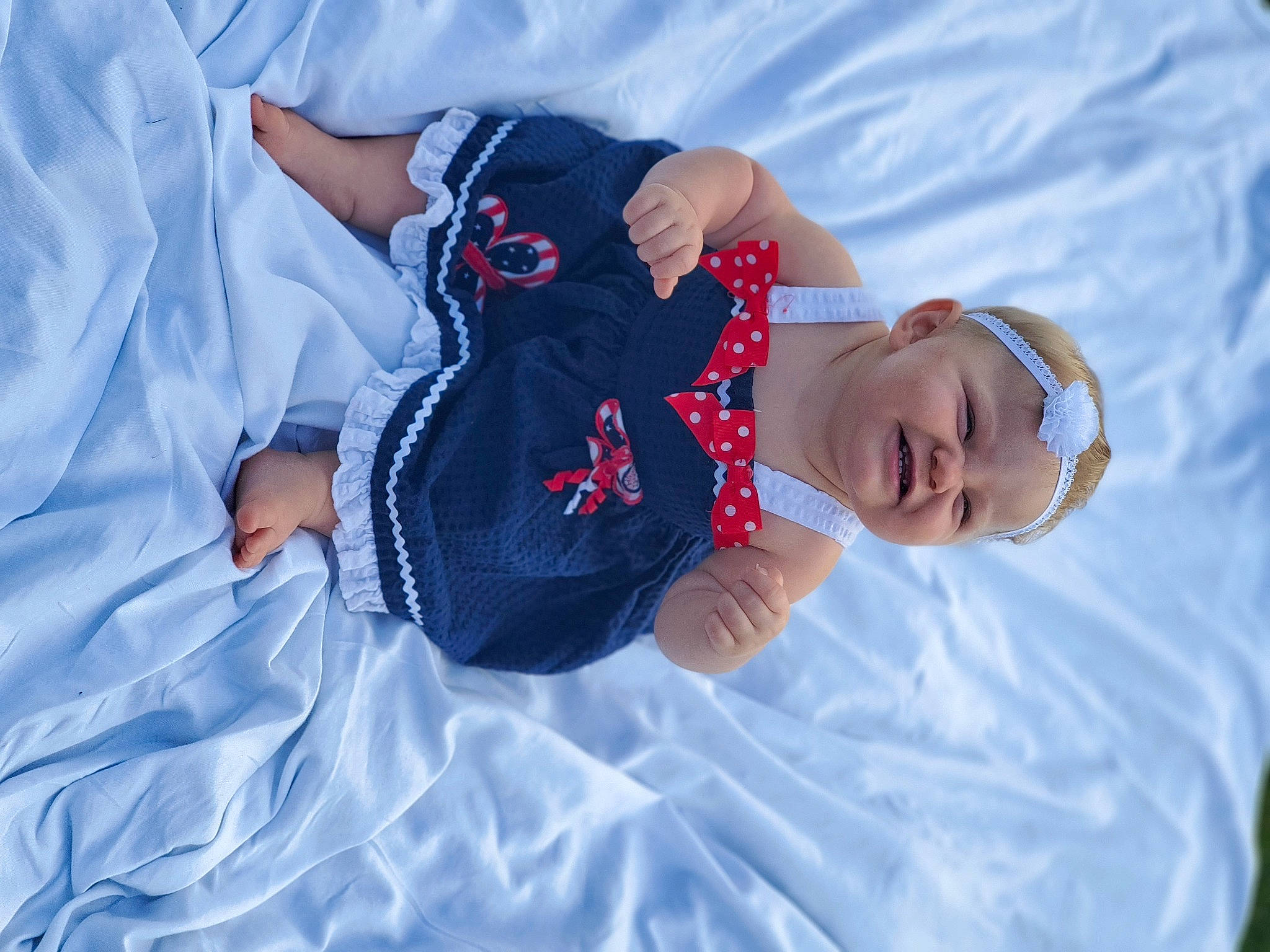 Gabriella is registered to the contest to win money with this photo: arm, azure, baby, child, cloud, electric_blue, freezing, fun, grass, hand, happy, leisure, pattern, people_in_nature, person, recreation, sky, smile, t_shirt, toddler