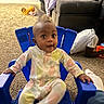Amyra joined the competition — help win amazing prizes! baby, child, indoor, blue_chair, onesie, carpet, couch, blanket, clothing, toy, person, floor, playtime, home, furniture, curious, wide_eyes, sitting, relaxed, carpeted_floor