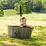 toddler, child, metal_tub, outdoor, grass, nature, sunlight, smile, portrait, greenery, field, trees, baby, summer, playful, happy, one_person, casual_clothing, daylight, cute