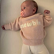 Maddie joined the competition — help win amazing prizes! baby, infant, pacifier, sweater, knitted, pink, white_pants, lying_down, soft_surface, newborn, cute, child, sleepwear, cozy, indoors, portrait, small_hands, small_feet, face, head