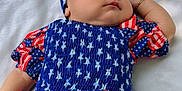 Rachel joined the competition — help win amazing prizes! baby, sleeping, headband, bow, dress, stars, stripes, red, white, blue, outdoor, blanket, child, peaceful, infant, portrait, clothing, pattern, resting, cute