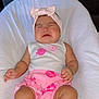 baby, infant, pink_bow, headband, white_tank_top, pink_shorts, pink_socks, cushion, white_blanket, crying, face, skin, person, baby_clothing, indoors, leather_background, child, expression, sitting, cute