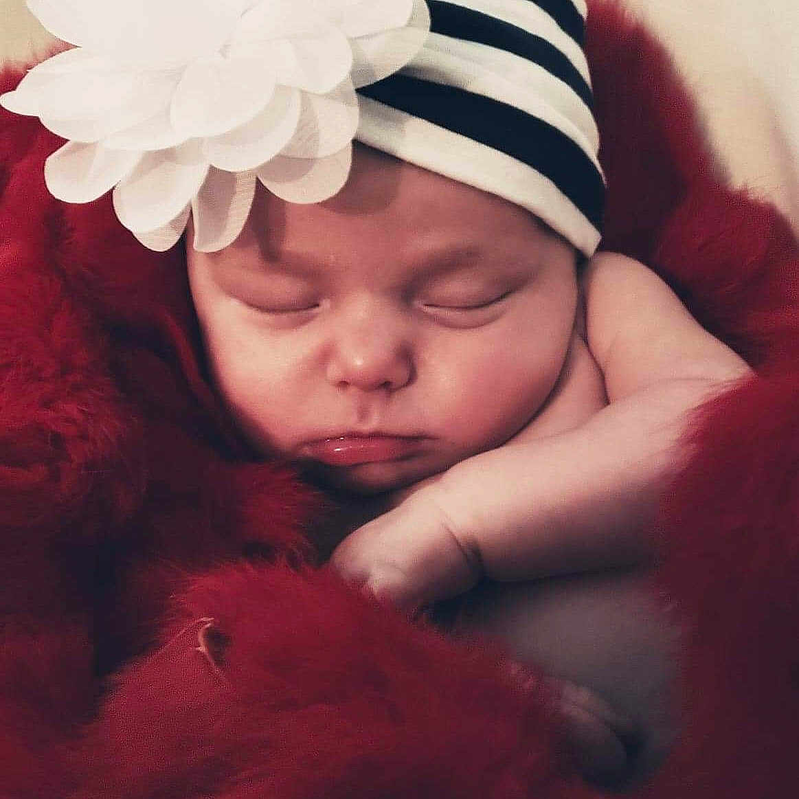 Samara is registered to the contest to win money with this photo: cheek, child, flower, girl, hair_accessory, headband, headgear, headpiece, headwear, infant, lip, person, pink, red, skin, smile, toddler