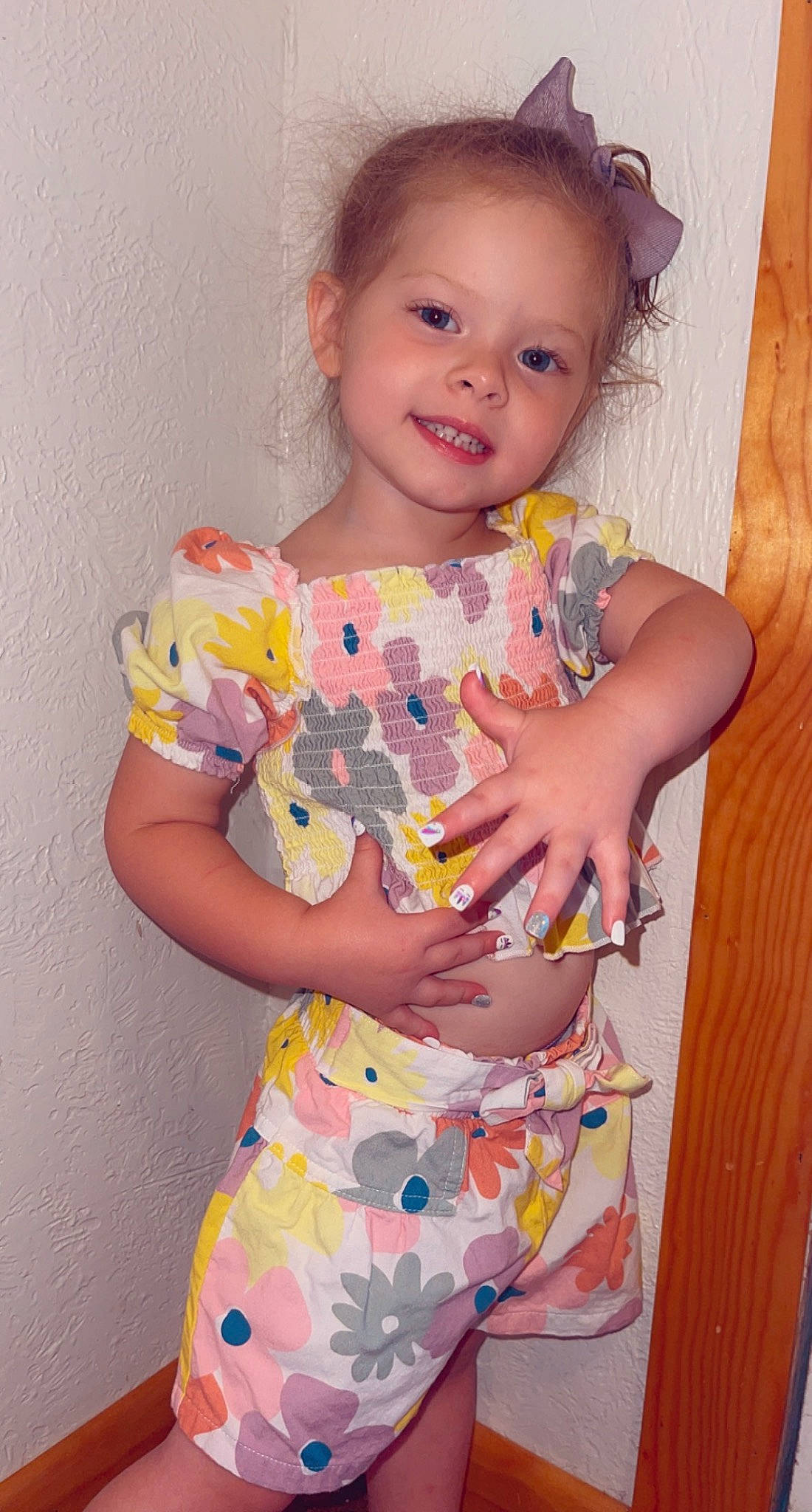 Addison is registered to the contest to win money with this photo: arm, baby_toddler_clothing, child, day_dress, dress, happy, human_body, iris, joy, linens, magenta, neck, one_piece_garment, pattern, person, pink, play, sitting, sleeve, smile