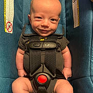 John joined the competition — help win amazing prizes! baby, car_seat, smile, infant, safety_harness, blue_fabric, warning_label, child, cute, young, seatbelt, indoor, portrait, infant_clothing, baby_face, small_person, happy, secure, close_up, human