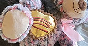 Atlas joined the competition — help win amazing prizes! cat, stuffed_toy, bed, striped_bedspread, gray_cat, plush_toy, teddy_bear, pink_ribbon, golden_heart, cozy, indoor, pet, animal, feline, soft_texture, cute, relaxed, cuddling, toy, sleepy
