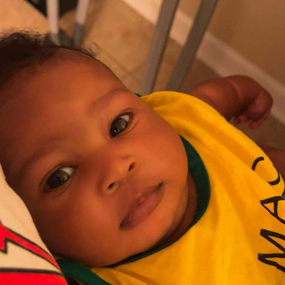 Ja'Majesty joined the competition — help win amazing prizes! arm, baby, bib, casual, closeup, clothing, comfort, expression, face, floor, furniture, head, indoors, infant, lying, person, portrait, skin, yellow, young