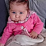 baby, child, toddler, blue_eyes, pink_clothing, pigtails, hair_ties, blanket, couch, cushion, scarf, unicorn_pattern, indoor, portrait, cute, cozy, soft_texture, infant, person, seated