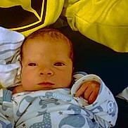 Giovanni is registered to the contest to win money with this photo: baby, child, closeup, clothing, cute, face, hand, indoor, infant, newborn, newborn_baby, onesie, pattern, person, portrait, resting, sleepwear, soft, warm, yellow_blanket