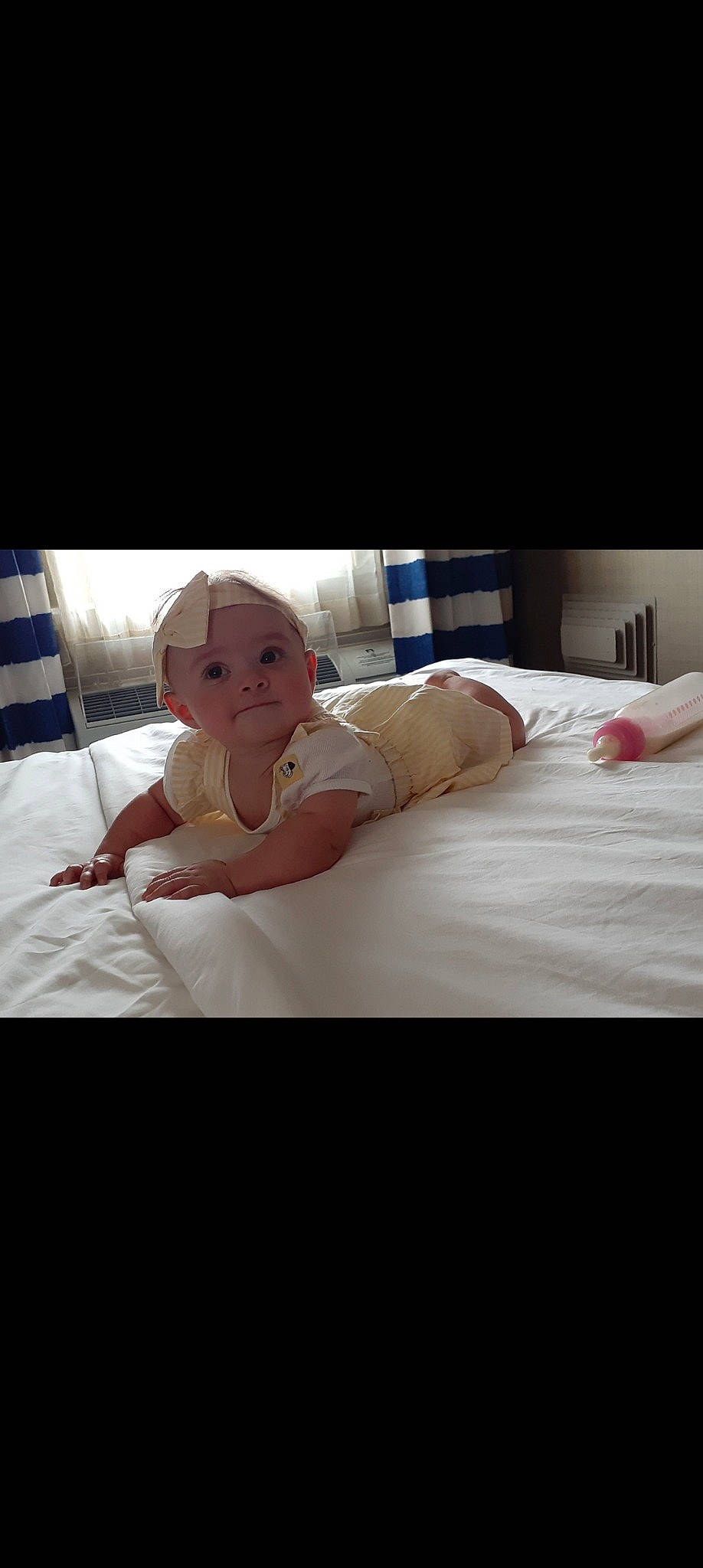 Helena is registered to the contest to win money with this photo: bed, bed_frame, bed_sheet, bedding, bedroom, child, comfort, dress, duvet, event, flooring, happy, headwear, linens, mattress, mattress_pad, person, pillow, room, textile