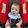 baby, bib, bright_colors, car_seat, child, clothing, cute, expression, face, grass, hand, infant, outdoor, plush_toy, portrait, red, safety_harness, sitting, striped_clothing, young_child
