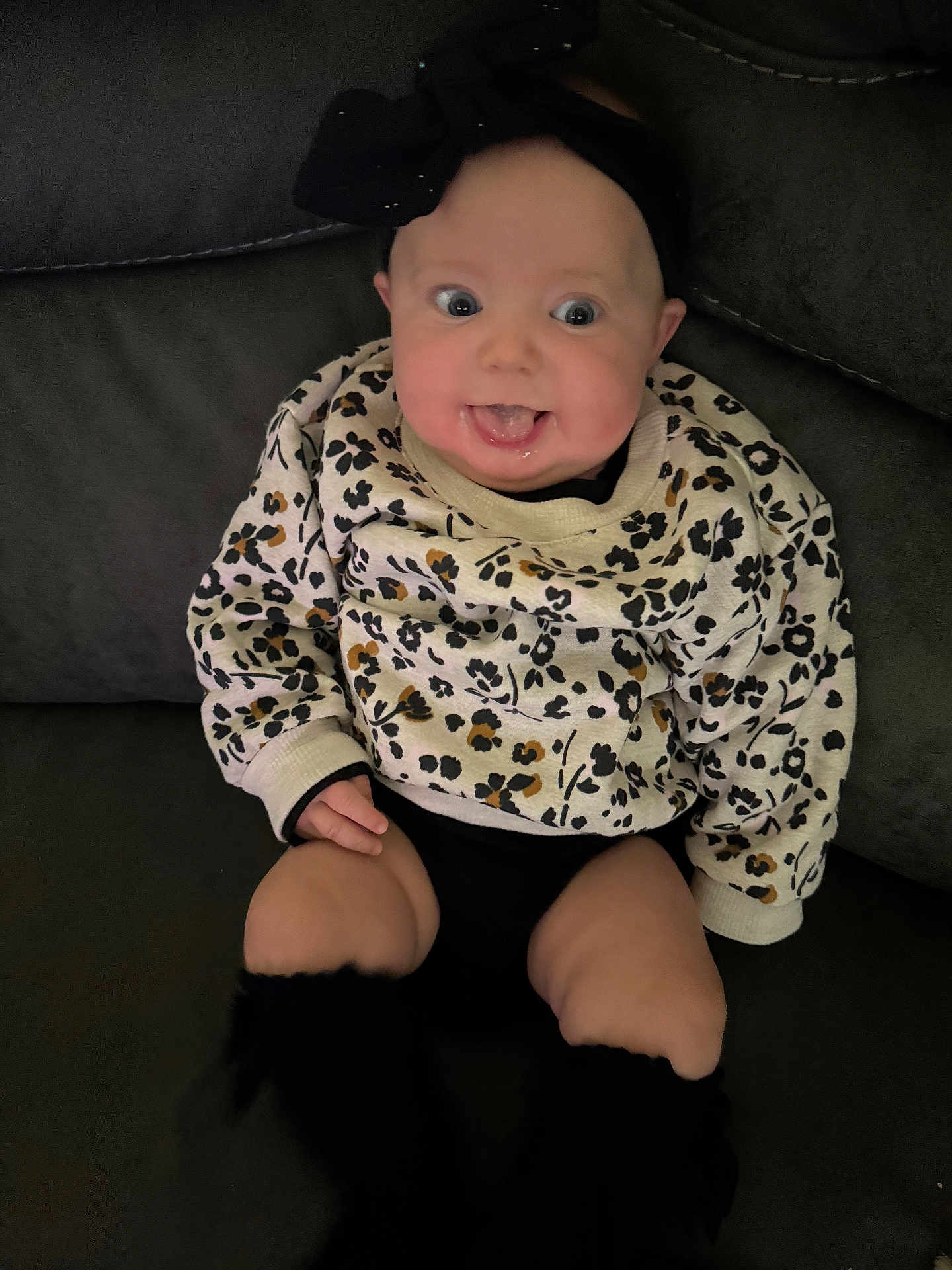 Aurora joined the competition — help win amazing prizes! baby, child, smiling, sitting, couch, sweater, headband, black_leg_warmers, happy, indoor, face, person, cute, infant, portrait, clothing, home, expression, young, fun