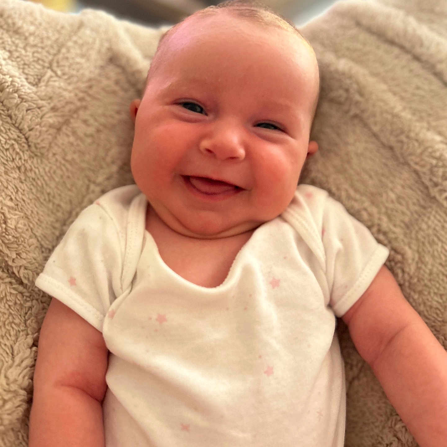 Margot joined the competition — help win amazing prizes! baby, blanket, child, chubby_cheeks, cozy, cute, face, happy, indoors, infant, newborn, onesie, person, portrait, relaxed, skin, smiling, soft_texture, warm_lighting, young_child