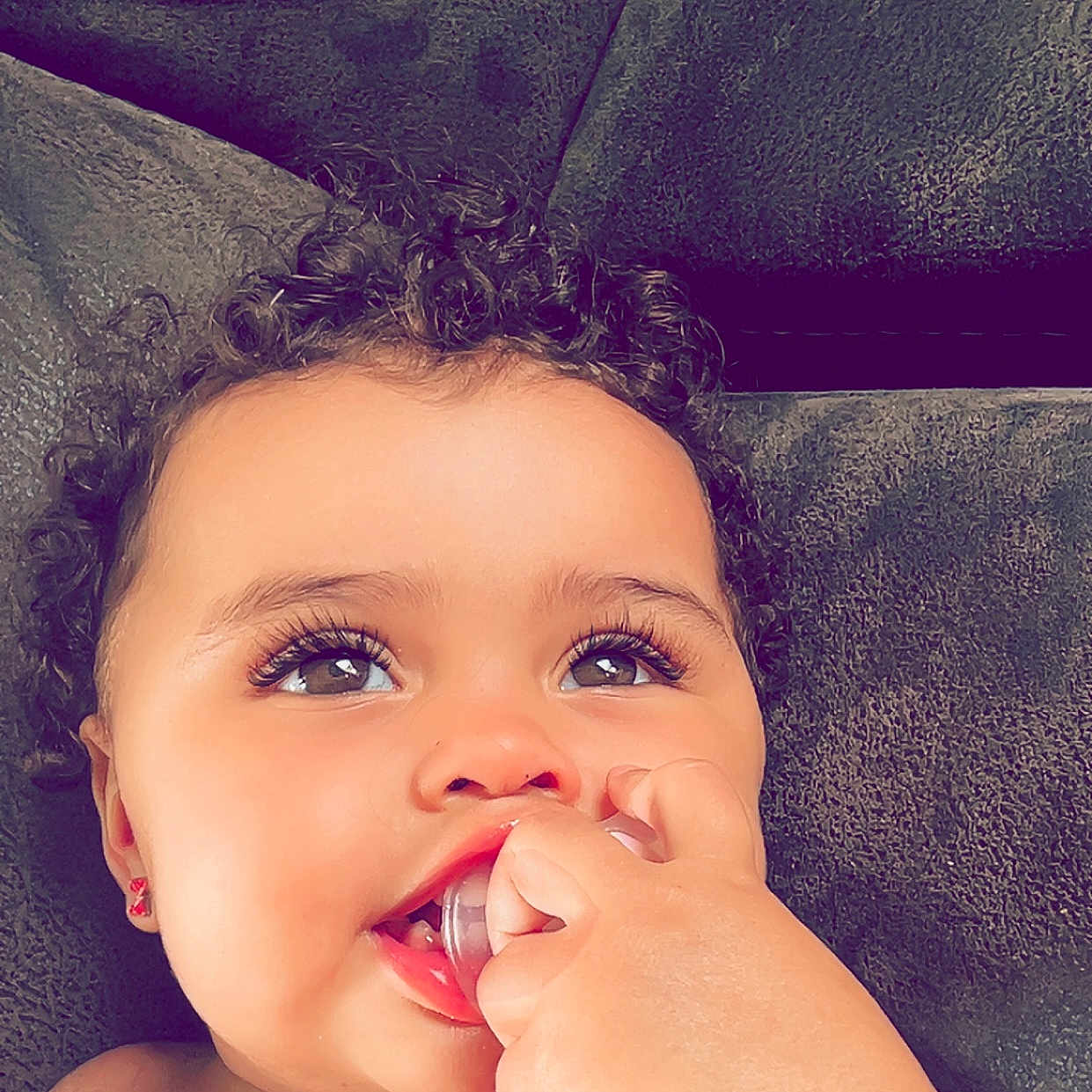 Akia joined the competition — help win amazing prizes! baby, biting, bodypart, cosmetics, couch, eating, face, finger, food, furniture, hand, happy, head, lipstick, mouth, person, photography, portrait, smile, teeth