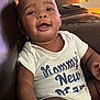 Liam joined the competition — help win amazing prizes! baby, smiling, onesie, white_clothing, sitting, happy, indoor, couch, leather, infant, chubby_cheeks, face, human, child, keyboard, background, bright_eyes, hand, portrait, casual