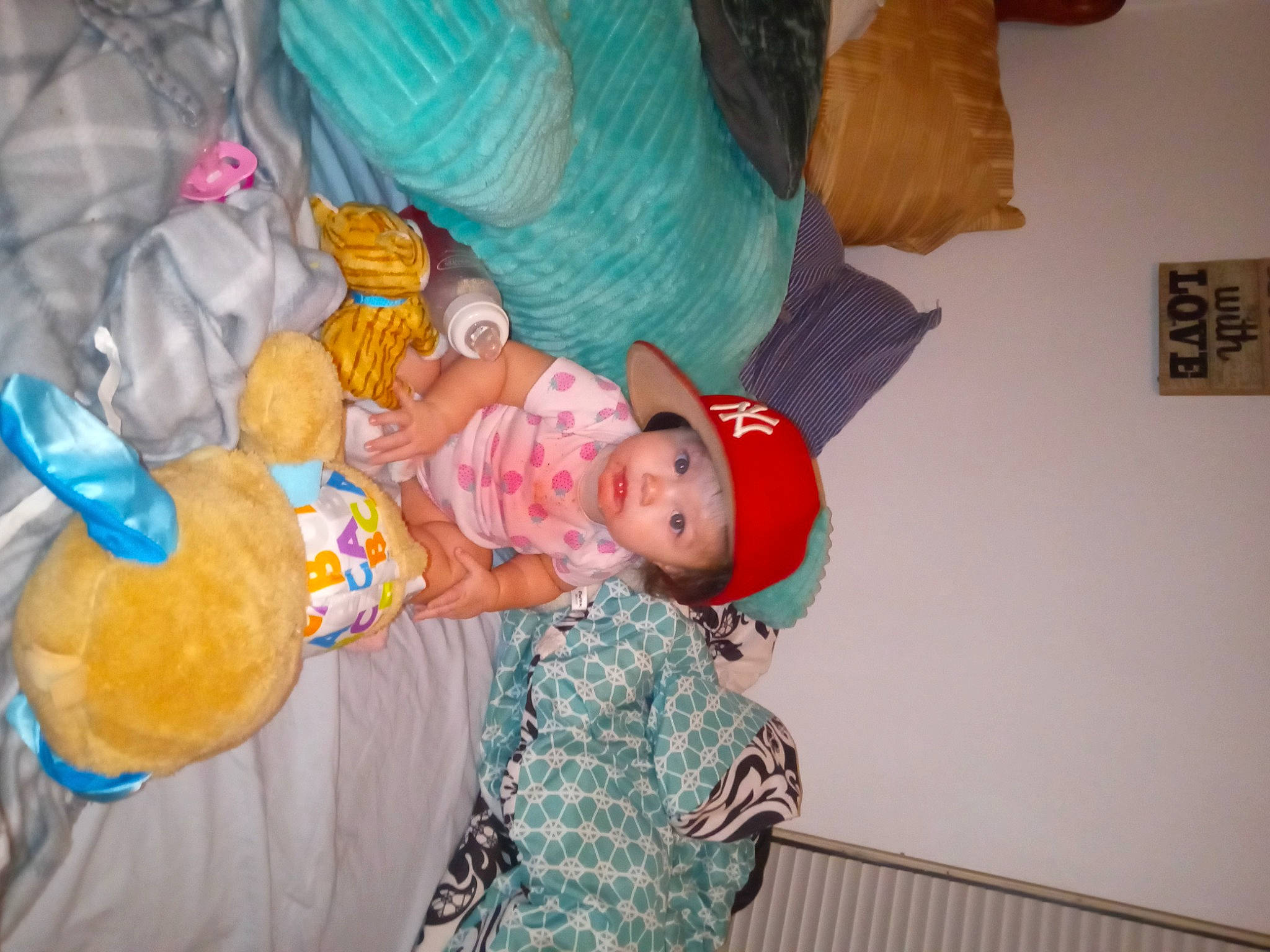 Madison is registered to the contest to win money with this photo: baby, baby_products, baby_toddler_clothing, child, comfort, event, eye, fun, happy, hat, headwear, person, pink, room, stuffed_toy, textile, toddler, toy