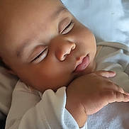 Liam is registered to the contest to win money with this photo: baby, sleeping, infant, white_clothing, hand, face, closed_eyes, soft_light, blanket, cozy, peaceful, portrait, cute, child, skin, newborn, resting, indoors, closeup, toddler