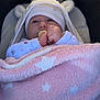 Adèle participe au concours pour gagner de l'argent avec cette photo : baby, infant, stroller, car_seat, pacifier, pink_blanket, hooded_hat, beanie, hands, eyes, blanket, star_pattern, soft_texture, cute, portrait, close_up, sunlight, cozy, clothing, canopy