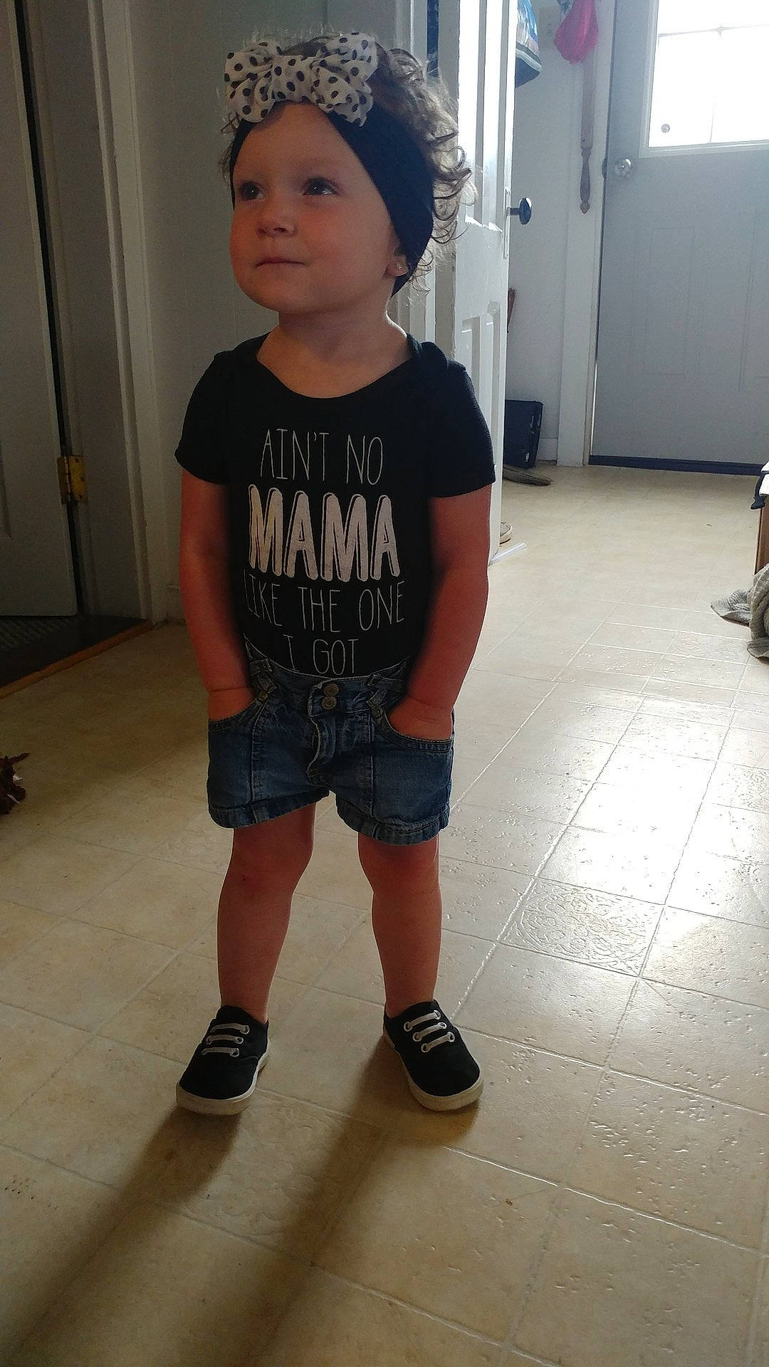 Echo is registered to the contest to win money with this photo: arm, child, clothing, cool, day, floor, footwear, fun, girl, headgear, jeans, joint, leg, person, product, shorts, shoulder, snapshot, standing, t_shirt