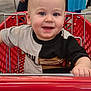toddler, child, shopping_cart, smile, happy, face, clothing, red, person, store, shopping, hand, shorts, retail, cute, baby, indoor, portrait, seat, metal_bar