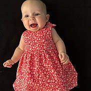 Romy participe au concours pour gagner de l'argent avec cette photo : arms, baby, background, child, cute, dress, face, floral_pattern, happy, human, infant, joyful, legs, portrait, red_dress, sitting, skin, smiling, studio, young_child