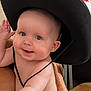 Romy participe au concours pour gagner de l'argent avec cette photo : arm, baby, blue_eyes, child, cowboy_hat, curious, cute, diaper, facial_expression, hand, headwear, holding, indoor, infant, person, plush, portrait, skin, smile, tattoo