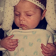 Ember is registered to the contest to win money with this photo: accessories, baby, bed, blanket, bodypart, cradle, crib, face, finger, furniture, hand, head, infantbed, jewelry, newborn, person, photography, portrait, ring, sleeping