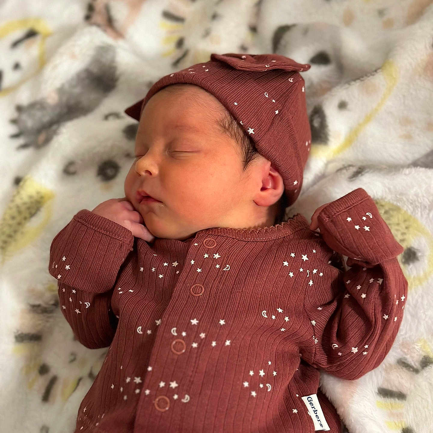 Ember joined the competition — help win amazing prizes! baby, bed, blanket, bonnet, cap, clothing, face, glove, hat, head, hoodie, knitwear, newborn, person, photography, portrait, sleeping, sweater, sweatshirt, yawning