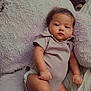 Dezeriah Sparks is registered to the contest to win money with this photo: baby, infant, plush_toy, onesie, socks, indoor, bed, blanket, couch, child, portrait, relaxed, cute, soft_texture, furniture, sleepwear, person, toddler, resting, young_child