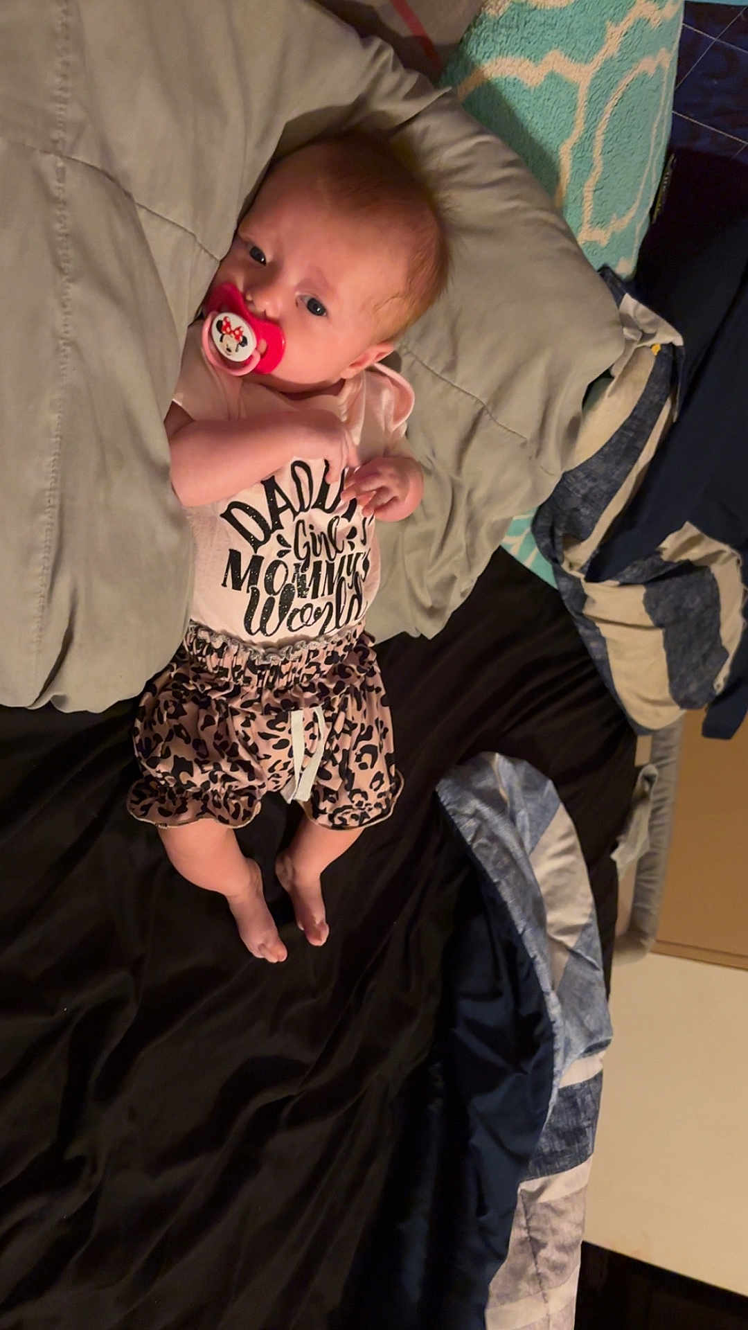 Jolene joined the competition — help win amazing prizes! baby, infant, pacifier, blanket, bed, pillow, clothing, toddler, cute, sleepwear, child, indoor, face, person, lying_down, text_on_clothing, leopard_print, pink, skin, young