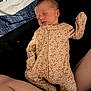 Jolene is registered to the contest to win money with this photo: newborn, baby, sleeping, floral_onesie, infant, skin, legs, blanket, fabric, pattern, comfort, peaceful, rest, cute, child, person, indoor, closeup, soft_lighting, toddler