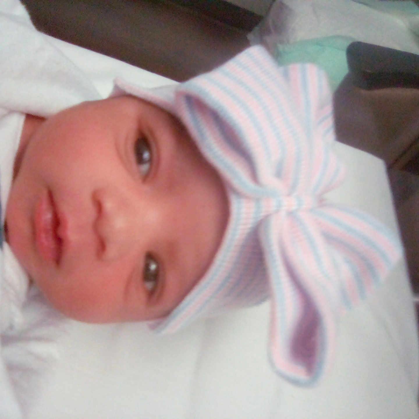 Gabrielle is registered to the contest to win money with this photo: baby, bed, blanket, bonnet, clothing, cradle, crib, face, furniture, hat, head, hood, infantbed, newborn, person, photography, portrait, towel