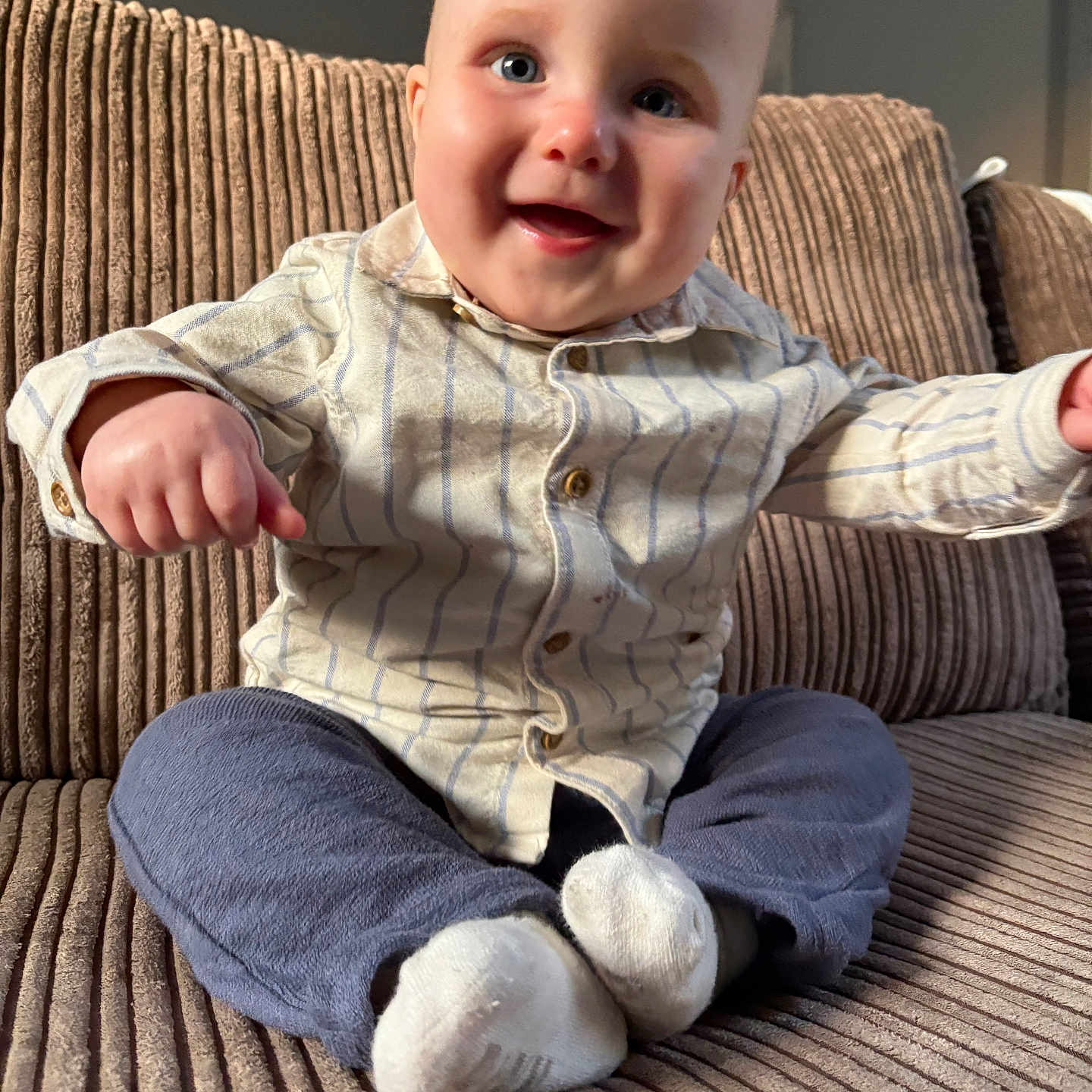 Hunter is registered to the contest to win money with this photo: baby, babylaughing, bodypart, clothing, couch, face, finger, furniture, hand, happy, head, hosiery, jeans, pants, person, photography, portrait, sitting, smile, sock