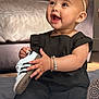 baby, child, sneaker, black_clothing, headband, bracelet, smiling, sitting, indoor, couch, footwear, happy, accessory, person, portrait, cute, infant, fashion, soft_light, floor