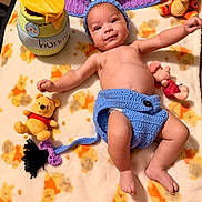 Jacieon is registered to the contest to win money with this photo: baby, infant, smiling, plush_toys, winnie_the_pooh, eeyore_costume, blanket, piglet, tigger, cute, child, soft_toys, lying_down, handmade_clothing, blue, yellow, orange, happy, indoors, portrait