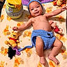 baby, infant, smiling, plush_toys, winnie_the_pooh, eeyore_costume, blanket, piglet, tigger, cute, child, soft_toys, lying_down, handmade_clothing, blue, yellow, orange, happy, indoors, portrait