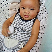 King joined the competition — help win amazing prizes! baby, child, smiling, striped_clothing, polka_dot, seat, cushion, infant, cute, portrait, hand, face, eyes, indoor, comfortable, soft_toy, happy, young, wearing, sitting