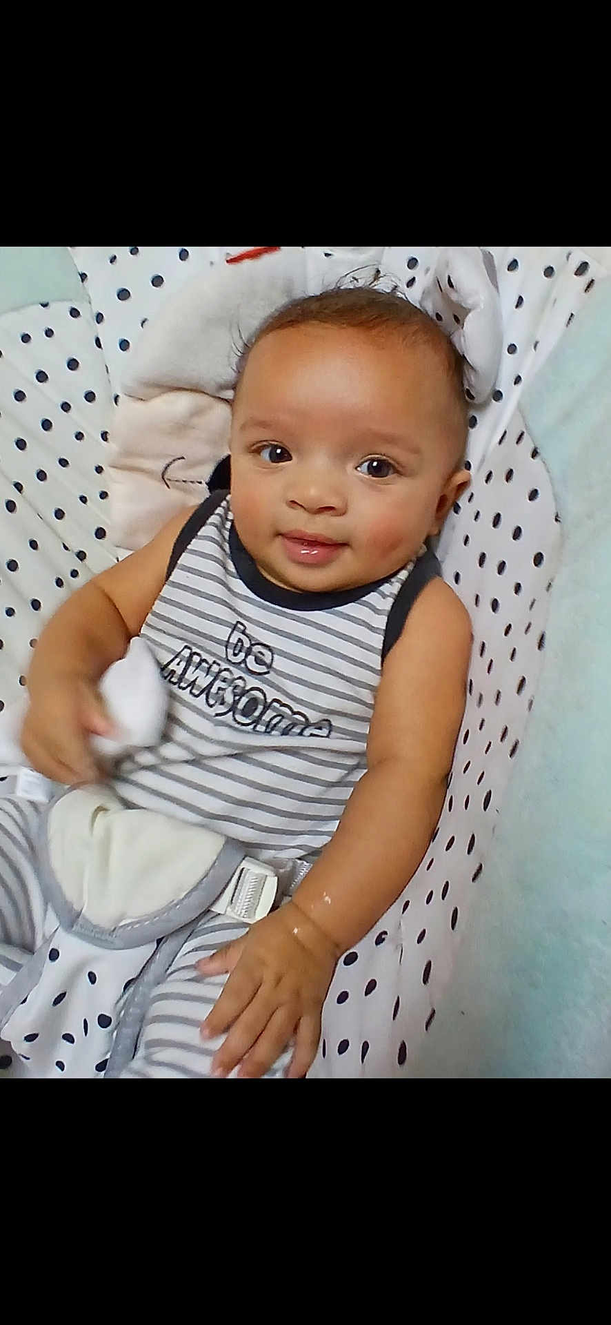 King joined the competition — help win amazing prizes! baby, child, smiling, striped_clothing, polka_dot, seat, cushion, infant, cute, portrait, hand, face, eyes, indoor, comfortable, soft_toy, happy, young, wearing, sitting