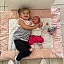 Kelly participe au concours pour gagner de l'argent avec cette photo : child, baby, siblings, hugging, mat, pink, white, floor, tiles, plush_toy, happy, smiling, clothing, socks, indoor, cute, family, portrait, toddler, infant