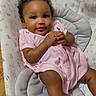 baby, child, infant, portrait, smiling, happy, sitting, pink_outfit, hair_bow, curly_hair, dark_skin, face, arms, legs, baby_seat, cushion, bunny_pattern, indoor, wood_floor, photography